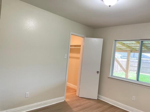 2120 Killington Dr, Harvey, LA 70058 - unfurnished bedroom featuring light wood-style floors, baseboards, a walk in closet, and a closet