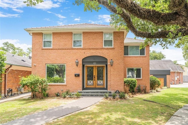 231 Audubon Blvd, New Orleans, LA 70125 - view of front of home featuring a front yard, brick siding, and french doors