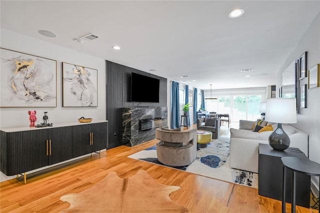 231 Audubon Blvd, New Orleans, LA 70125 - living room with wood finished floors, a high end fireplace, and recessed lighting