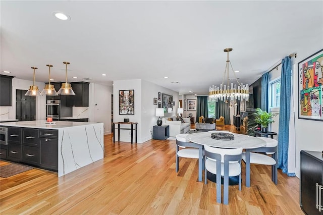 231 Audubon Blvd, New Orleans, LA 70125 - dining area featuring light wood-type flooring, a chandelier, recessed lighting, and baseboards