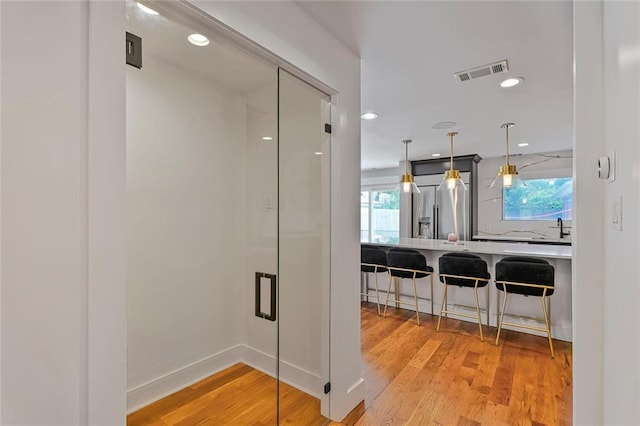 231 Audubon Blvd, New Orleans, LA 70125 - hall with light wood finished floors, healthy amount of natural light, and recessed lighting