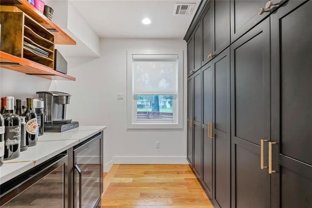 231 Audubon Blvd, New Orleans, LA 70125 - washroom with beverage cooler, recessed lighting, and light wood finished floors