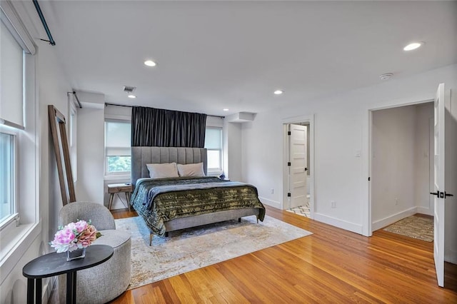 231 Audubon Blvd, New Orleans, LA 70125 - bedroom with wood finished floors, baseboards, recessed lighting, and connected bathroom