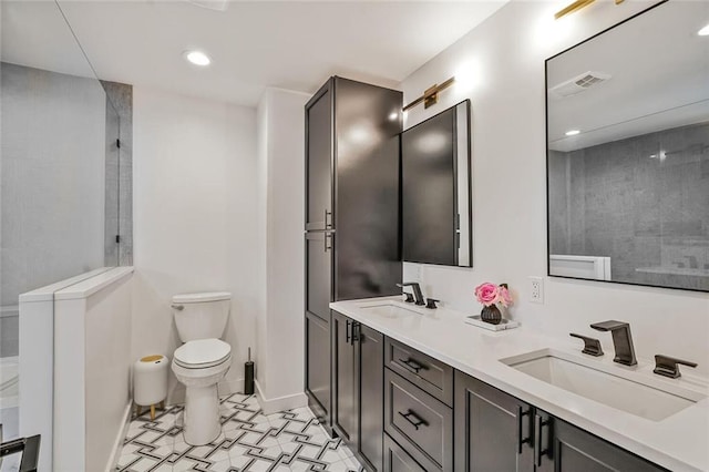 231 Audubon Blvd, New Orleans, LA 70125 - bathroom featuring toilet, double vanity, recessed lighting, baseboards, and a shower