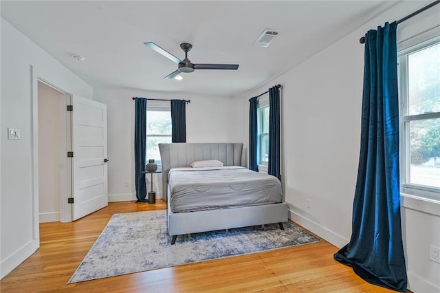 231 Audubon Blvd, New Orleans, LA 70125 - bedroom featuring multiple windows, wood finished floors, and baseboards