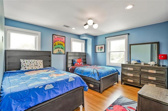231 Audubon Blvd, New Orleans, LA 70125 - bedroom featuring multiple windows, wood finished floors, recessed lighting, and baseboards