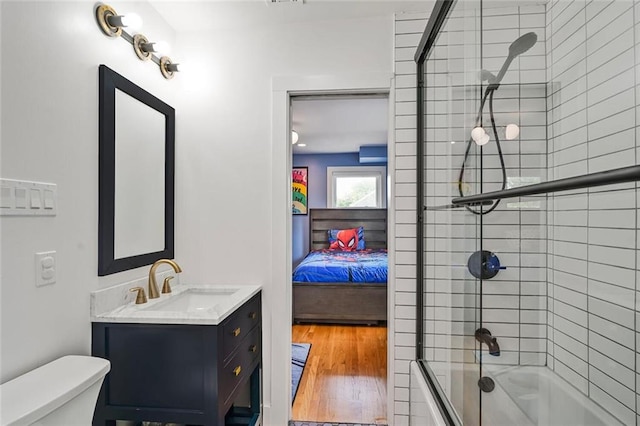 231 Audubon Blvd, New Orleans, LA 70125 - ensuite bathroom featuring shower / bath combination with glass door, vanity, toilet, and wood finished floors