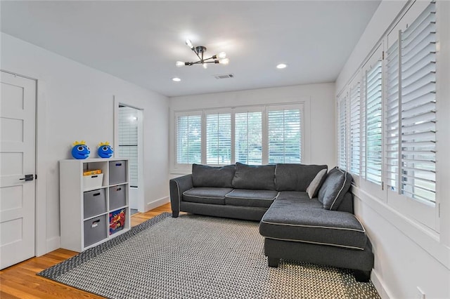 231 Audubon Blvd, New Orleans, LA 70125 - living room featuring light wood-type flooring, a chandelier, recessed lighting, and baseboards