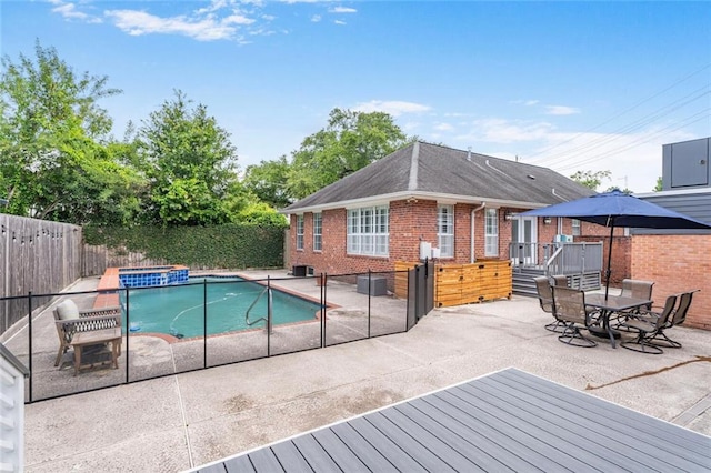 231 Audubon Blvd, New Orleans, LA 70125 - view of pool with a fenced backyard, a patio, a wooden deck, and a pool with connected hot tub