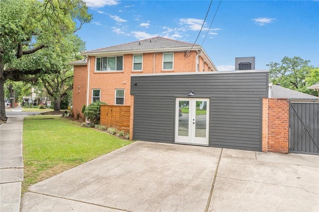 231 Audubon Blvd, New Orleans, LA 70125 - back of property with a yard, french doors, and brick siding