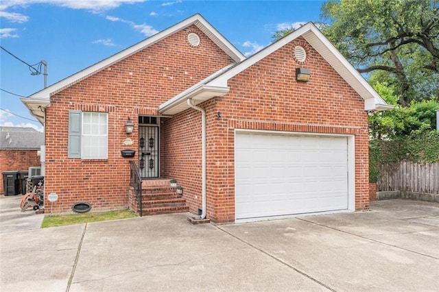231 Audubon Blvd, New Orleans, LA 70125 - traditional-style house with driveway, brick siding, and a garage