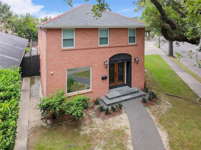 231 Audubon Blvd, New Orleans, LA 70125 - view of front of home with french doors, a front lawn, roof with shingles, and brick siding