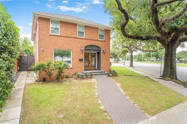 231 Audubon Blvd, New Orleans, LA 70125 - view of front facade featuring a front lawn, a gate, french doors, and brick siding