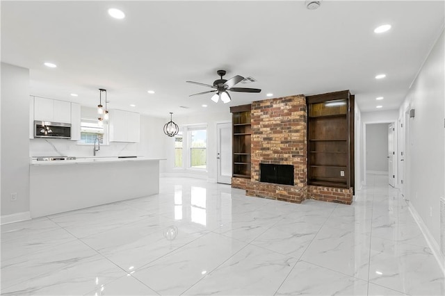 30 Normandy Dr, Kenner, LA 70065 - unfurnished living room with light marble finish flooring, recessed lighting, baseboards, and ceiling fan
