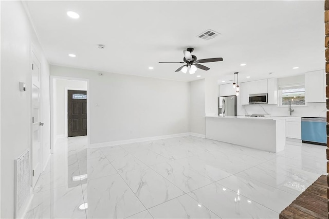 30 Normandy Dr, Kenner, LA 70065 - unfurnished living room with a ceiling fan, baseboards, a sink, recessed lighting, and light marble finish floors