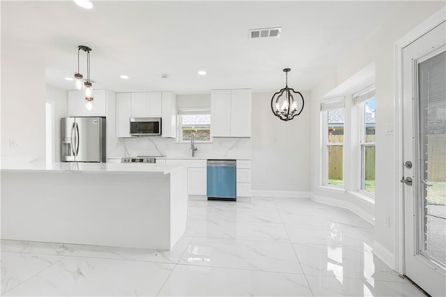 30 Normandy Dr, Kenner, LA 70065 - kitchen featuring stainless steel appliances, white cabinets, recessed lighting, light marble finish floors, and healthy amount of natural light