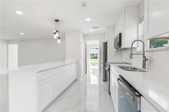 30 Normandy Dr, Kenner, LA 70065 - kitchen with stainless steel appliances, a sink, healthy amount of natural light, white cabinetry, and recessed lighting