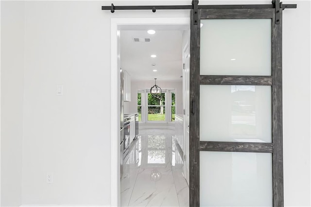 30 Normandy Dr, Kenner, LA 70065 - corridor featuring marble look tiles, recessed lighting, and a barn door