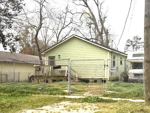 506 S Olive St, Hammond, LA 70403 - view of home's exterior with a deck and crawl space