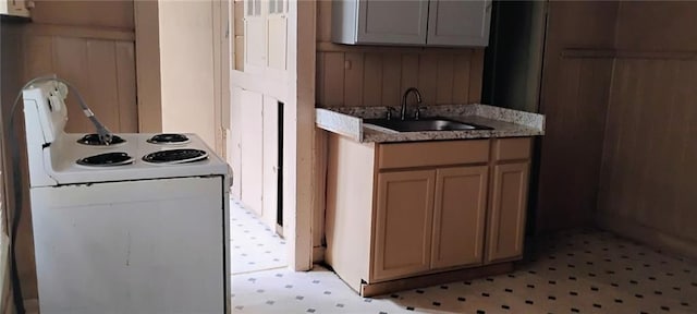 182224 Frenchmen St, New Orleans, LA 70116 - kitchen with white range with electric stovetop, a sink, light flooring, and light stone counters