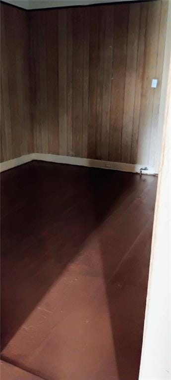 182224 Frenchmen St, New Orleans, LA 70116 - unfurnished room featuring wood walls and dark wood-style flooring