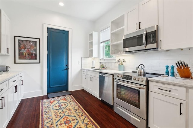 3429 Willow St, New Orleans, LA 70115 - kitchen featuring appliances with stainless steel finishes, a sink, open shelves, dark wood-style flooring, and backsplash
