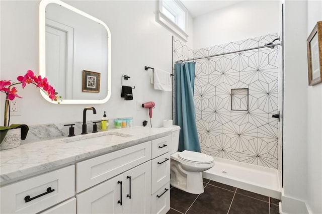 3429 Willow St, New Orleans, LA 70115 - bathroom featuring vanity, toilet, tile patterned flooring, and a tile shower