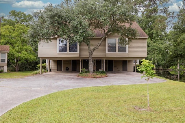 42 E Chamale Cv Unit 42, Slidell, LA 70460 - view of front of property featuring concrete driveway, a carport, and a front lawn