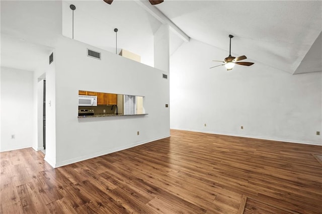 42 E Chamale Cv Unit 42, Slidell, LA 70460 - unfurnished living room featuring a ceiling fan, wood finished floors, high vaulted ceiling, a sink, and baseboards