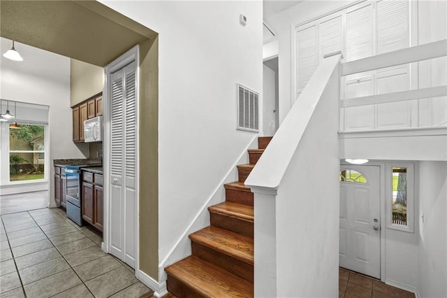42 E Chamale Cv Unit 42, Slidell, LA 70460 - stairway featuring tile patterned flooring and baseboards