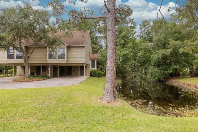 42 E Chamale Cv Unit 42, Slidell, LA 70460 - view of front of property featuring a carport, concrete driveway, and a front lawn