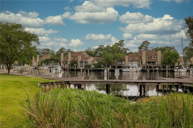 42 E Chamale Cv Unit 42, Slidell, LA 70460 - view of property's community with a boat dock, a residential view, a water view, and a lawn