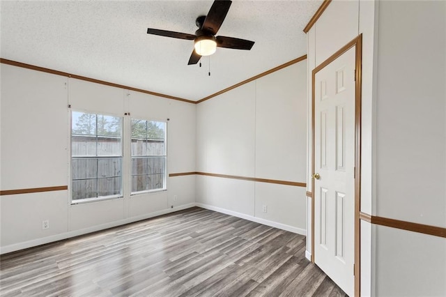 12175 Reid Rd, Amite, LA 70422 - empty room featuring wood finished floors, ornamental molding, ceiling fan, a textured ceiling, and baseboards