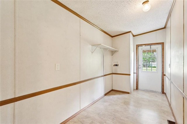 12175 Reid Rd, Amite, LA 70422 - interior space featuring crown molding, a textured ceiling, a decorative wall, and light wood-type flooring