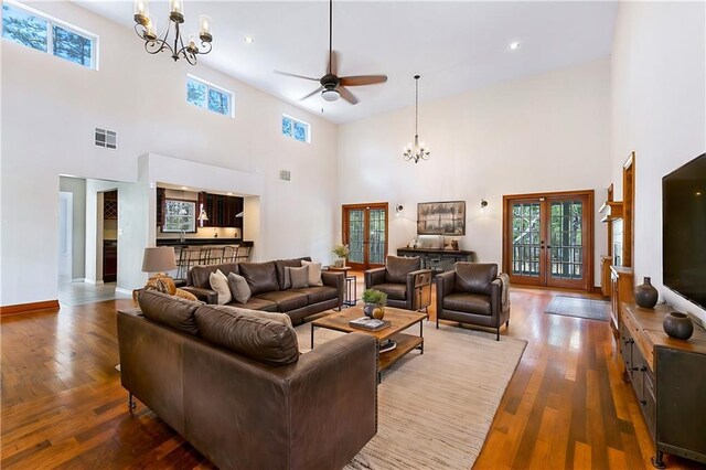59314 Cypress Bayou Ln, Lacombe, LA 70445 - living area with a chandelier, a towering ceiling, a ceiling fan, plenty of natural light, and wood finished floors