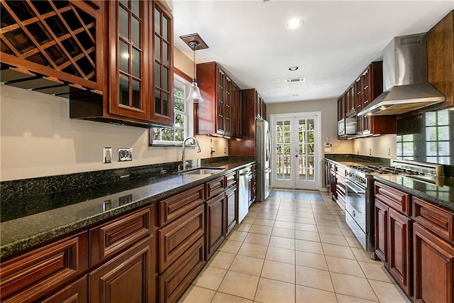 59314 Cypress Bayou Ln, Lacombe, LA 70445 - kitchen featuring wall chimney exhaust hood, stainless steel appliances, a sink, french doors, and light tile patterned floors