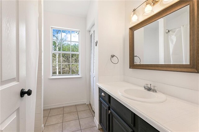 59314 Cypress Bayou Ln, Lacombe, LA 70445 - full bathroom with vanity, baseboards, and tile patterned floors