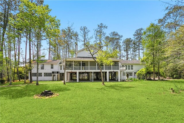 59314 Cypress Bayou Ln, Lacombe, LA 70445 - rear view of house featuring a sunroom, a yard, and a wooden deck