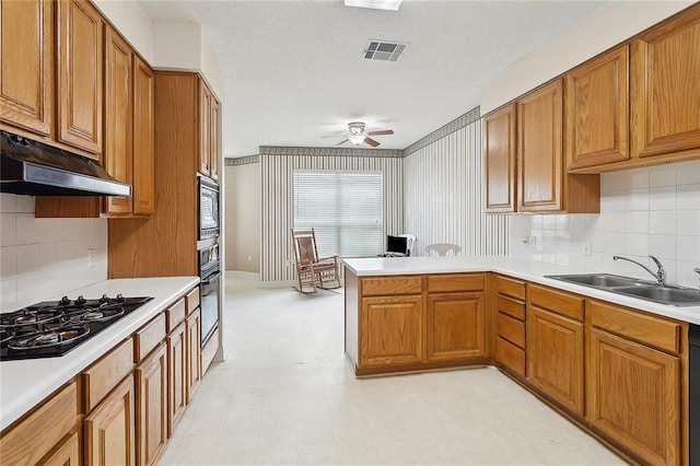1124 Indigo Ct, Slidell, LA 70460 - kitchen featuring a sink, black appliances, under cabinet range hood, and brown cabinetry