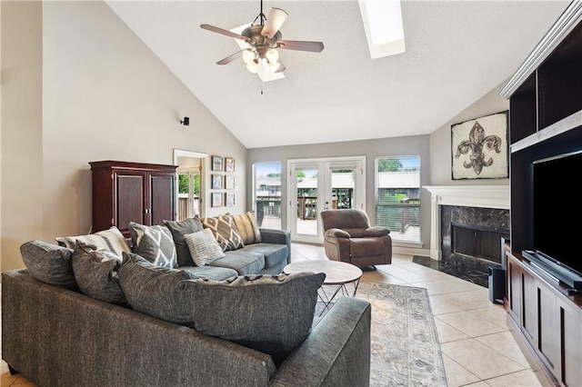127 Windward Passage St, Slidell, LA 70458 - living room featuring ceiling fan, light tile patterned floors, a premium fireplace, and high vaulted ceiling