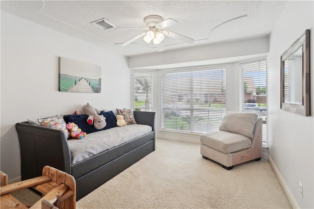127 Windward Passage St, Slidell, LA 70458 - living area featuring carpet, a textured ceiling, a ceiling fan, and baseboards