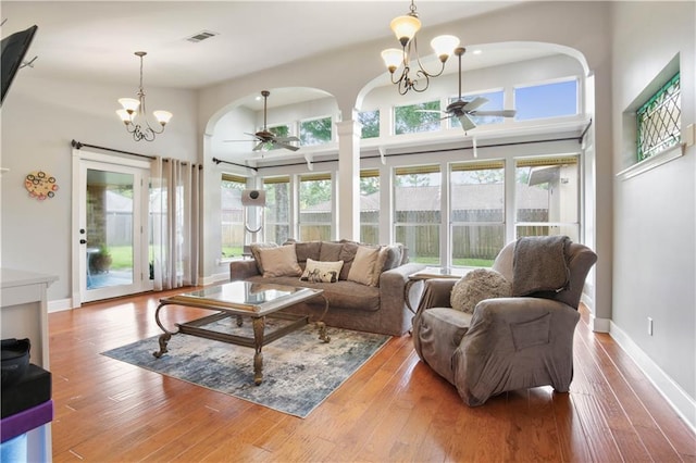 553 Manchester Dr, Slidell, LA 70461 - living room with a ceiling fan, arched walkways, a chandelier, and healthy amount of natural light