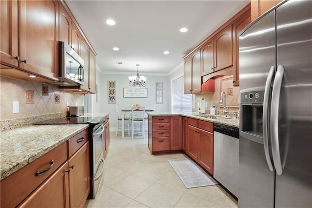 553 Manchester Dr, Slidell, LA 70461 - kitchen featuring stainless steel appliances, a sink, crown molding, tasteful backsplash, and light stone countertops