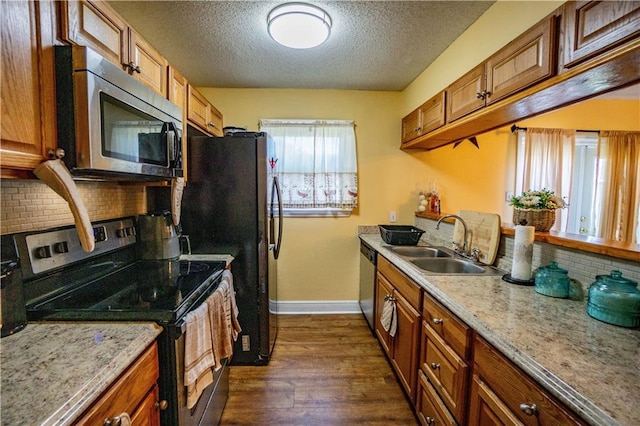 2404 Timbers Dr, Harvey, LA 70058 - kitchen with appliances with stainless steel finishes, a sink, baseboards, backsplash, and dark wood-type flooring