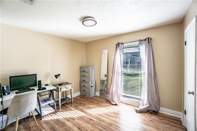 2404 Timbers Dr, Harvey, LA 70058 - office area featuring wood finished floors, baseboards, and a textured ceiling