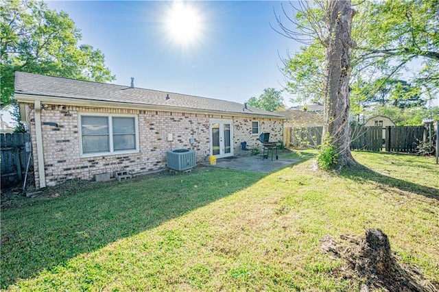 2404 Timbers Dr, Harvey, LA 70058 - back of property with french doors, brick siding, a patio area, and central air condition unit