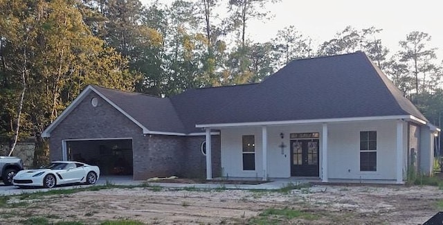 42155 Pasqua Rd, Ponchatoula, LA 70454 - view of front facade featuring a porch, a garage, and french doors