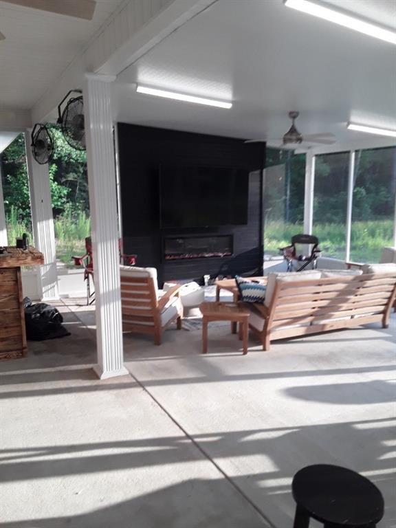 42155 Pasqua Rd, Ponchatoula, LA 70454 - view of patio / terrace featuring a ceiling fan and an outdoor living space with a fireplace