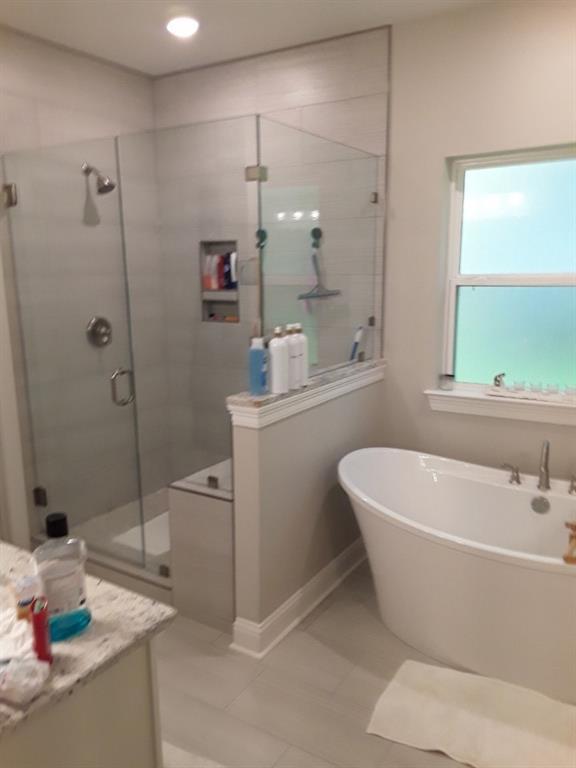 42155 Pasqua Rd, Ponchatoula, LA 70454 - full bathroom featuring a stall shower, a freestanding bath, tile patterned floors, and vanity