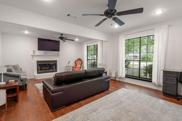 71164 Clipper Pl, Abita Springs, LA 70420 - living room with ceiling fan, crown molding, a fireplace, wood finished floors, and recessed lighting